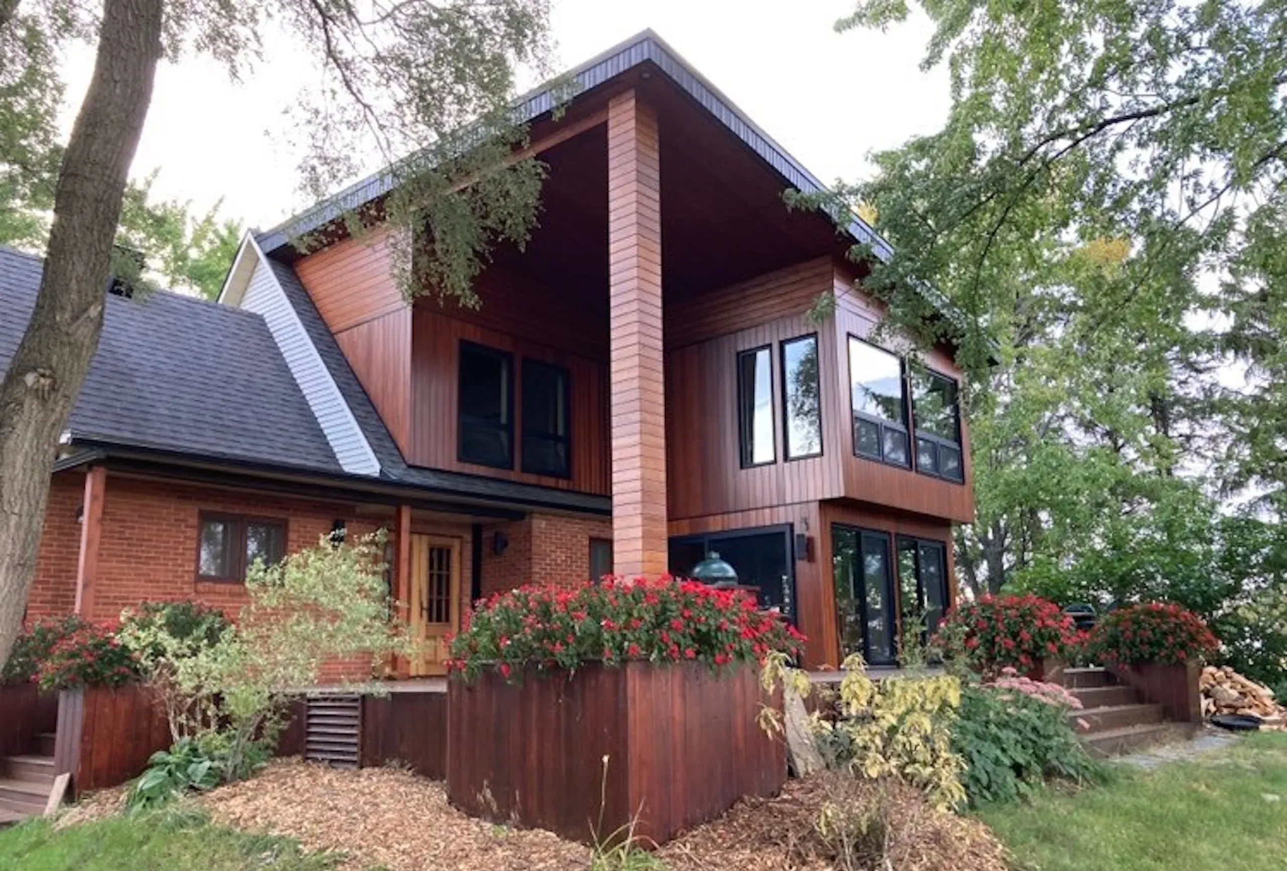 Vue en angle sur l'arrière d'une somptueuse demeure avec revêtement de bois fraîchement teint
